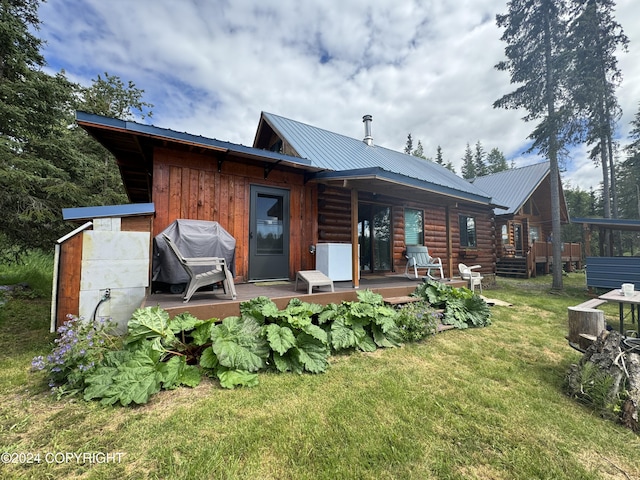 34335 Keystone Dr, Soldotna, AK 99669 - rear view of house featuring a yard, a metal roof, a deck, and log siding