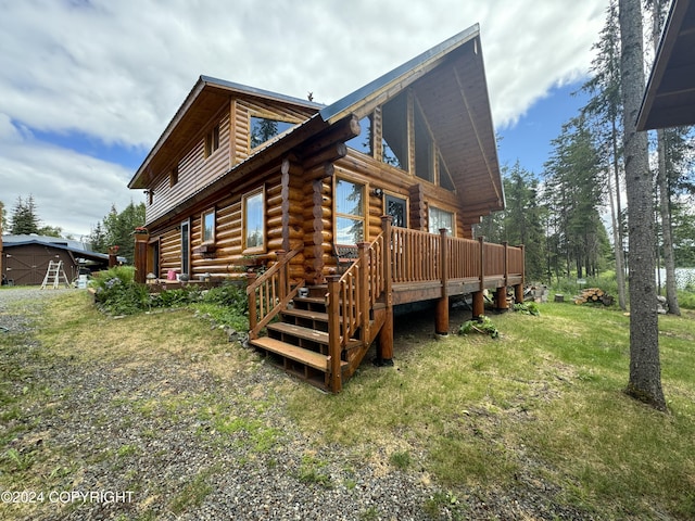 34335 Keystone Dr, Soldotna, AK 99669 - back of property with a deck, log siding, and a lawn
