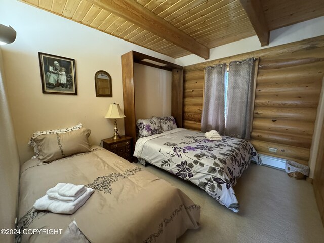 34335 Keystone Dr, Soldotna, AK 99669 - bedroom with log walls, a wood ceiling with exposed beams, and carpet flooring