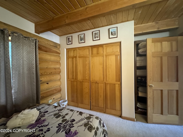 34335 Keystone Dr, Soldotna, AK 99669 - unfurnished bedroom with log walls, a wooden ceiling with exposed beams, and light carpet