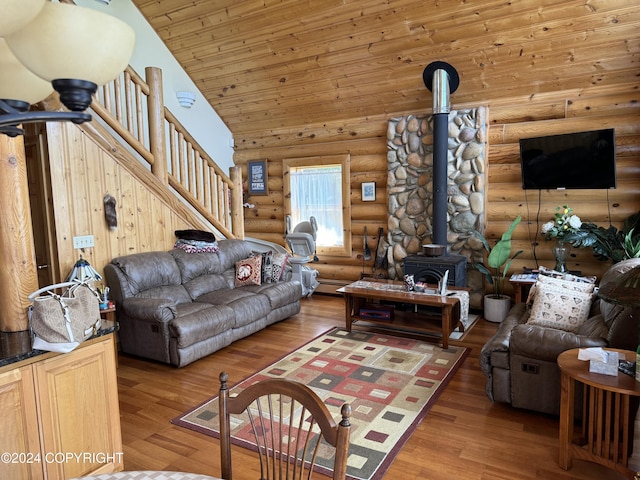 34335 Keystone Dr, Soldotna, AK 99669 - living room with rustic walls, stairs, a wood stove, wood finished floors, and wood ceiling