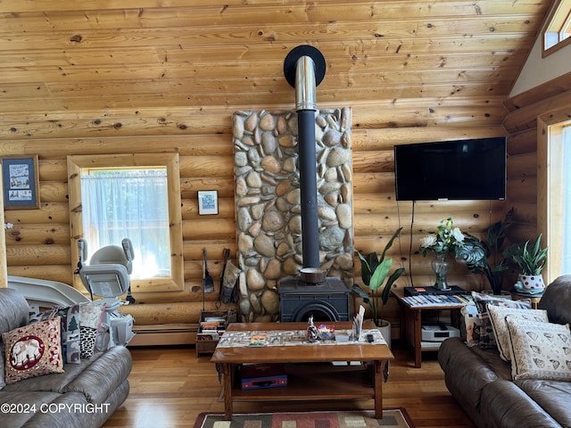 34335 Keystone Dr, Soldotna, AK 99669 - living area featuring a wood stove, rustic walls, wood-type flooring, wooden ceiling, and a baseboard radiator