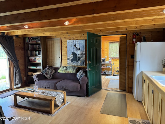 34335 Keystone Dr, Soldotna, AK 99669 - living room featuring wood walls, light wood-style floors, and beam ceiling