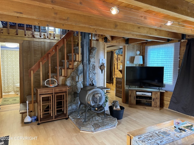 34335 Keystone Dr, Soldotna, AK 99669 - living area with wood finished floors, a wood stove, wood ceiling, wood walls, and stairs
