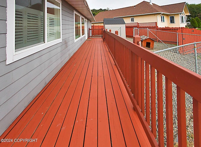 wooden deck with a fenced backyard