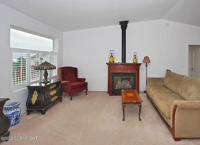 carpeted living area featuring vaulted ceiling