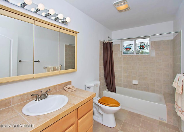 full bath featuring tile patterned floors, shower / bathtub combination with curtain, toilet, and vanity