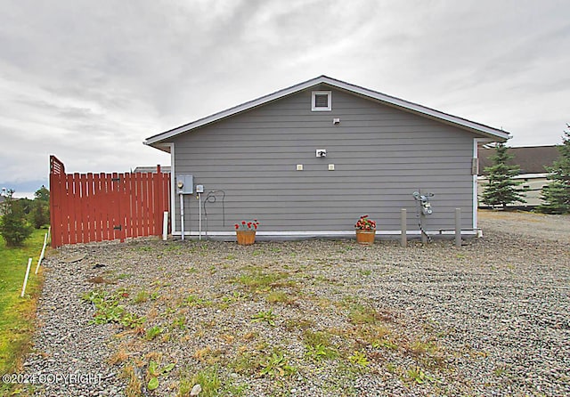 view of side of property featuring fence