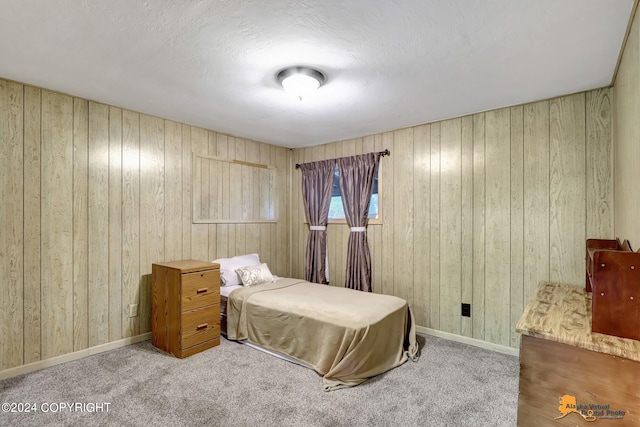 bedroom featuring carpet flooring and wooden walls