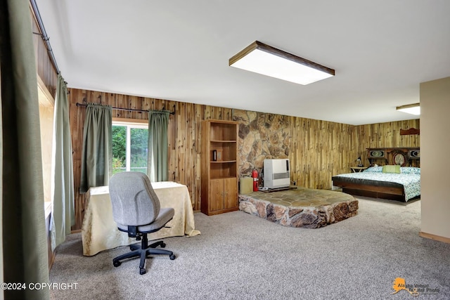 carpeted bedroom featuring wooden walls