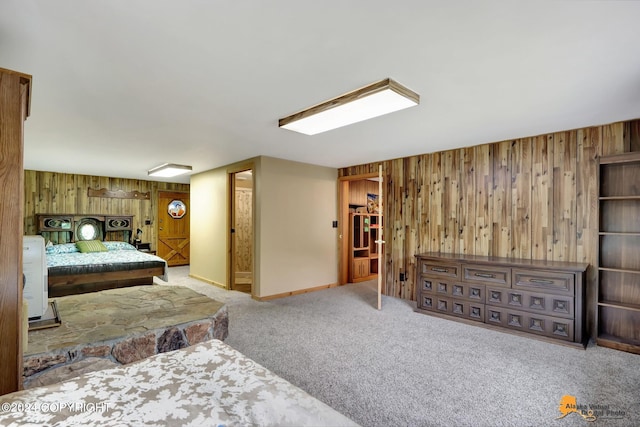 bedroom featuring wooden walls and carpet