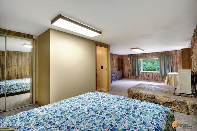 carpeted bedroom with wooden walls