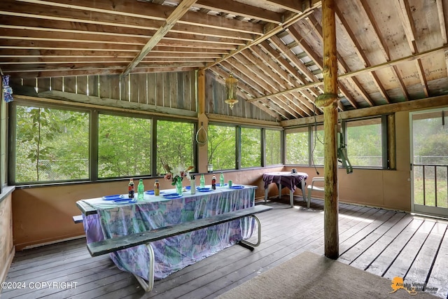 unfurnished sunroom featuring vaulted ceiling