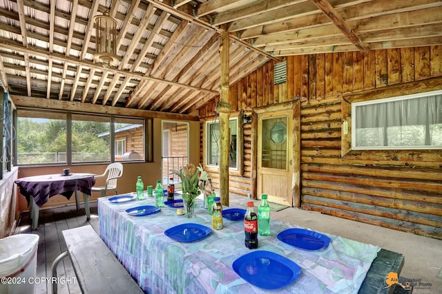 sunroom featuring vaulted ceiling and wood ceiling