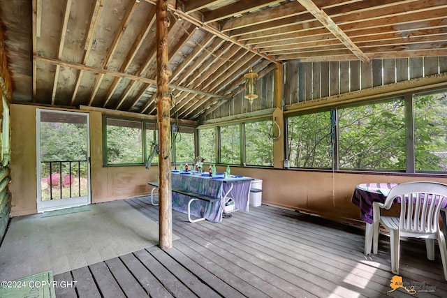 unfurnished sunroom featuring vaulted ceiling