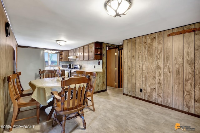 dining area featuring wooden walls