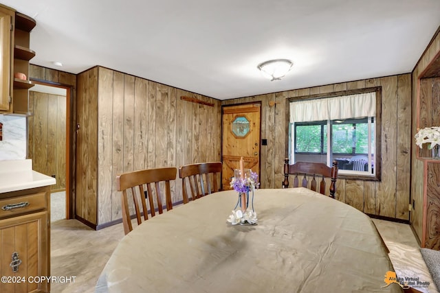 dining room with wood walls