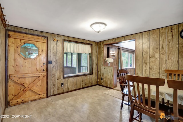 dining room with wood walls