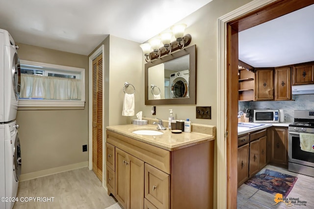 bathroom featuring stacked washer / dryer, wood-type flooring, sink, and backsplash