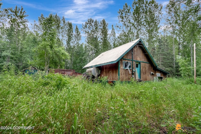 view of home's exterior with an outbuilding