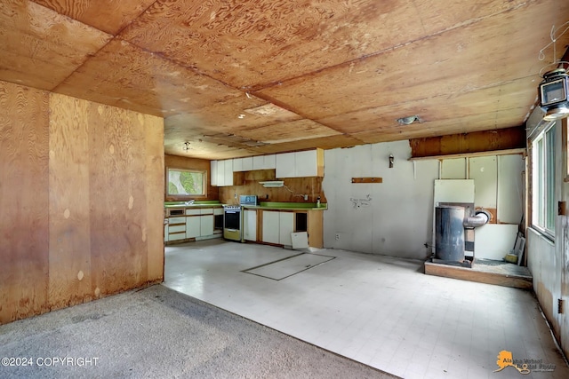 kitchen featuring white cabinetry, wooden ceiling, and gas range oven