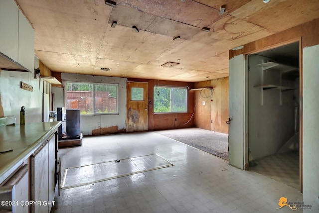 miscellaneous room with light tile patterned flooring and wooden walls