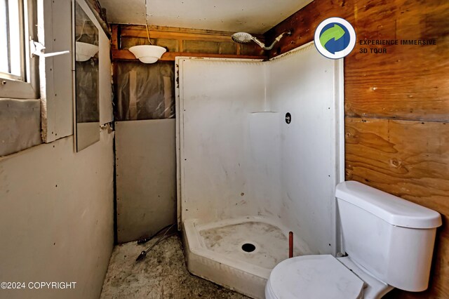 bathroom featuring a shower and toilet