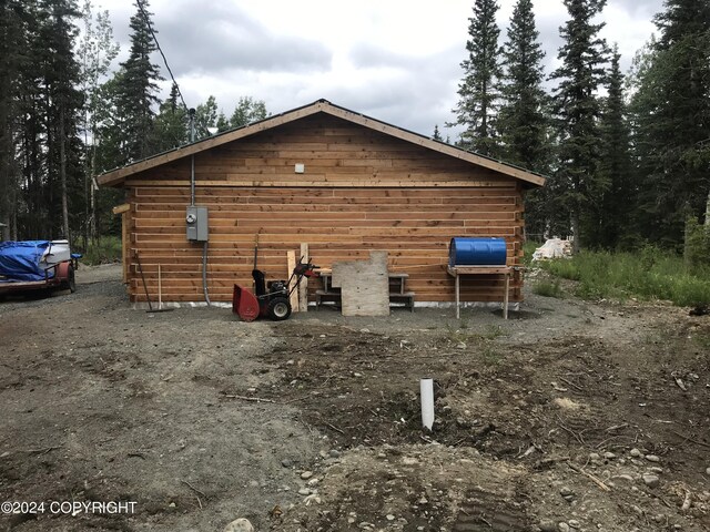 view of home's exterior with an outbuilding