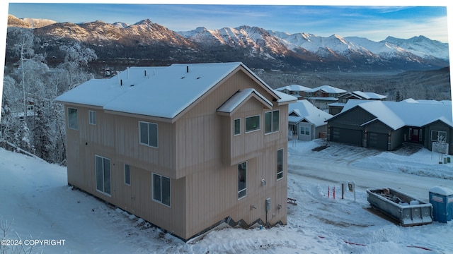 snowy aerial view with a mountain view