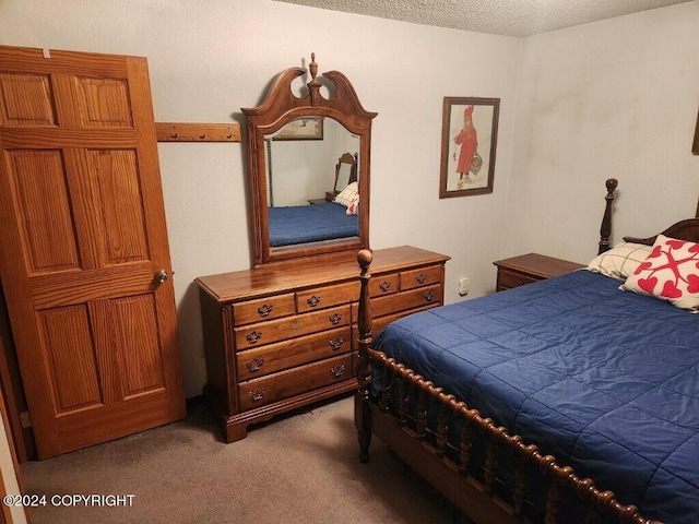 carpeted bedroom featuring a textured ceiling