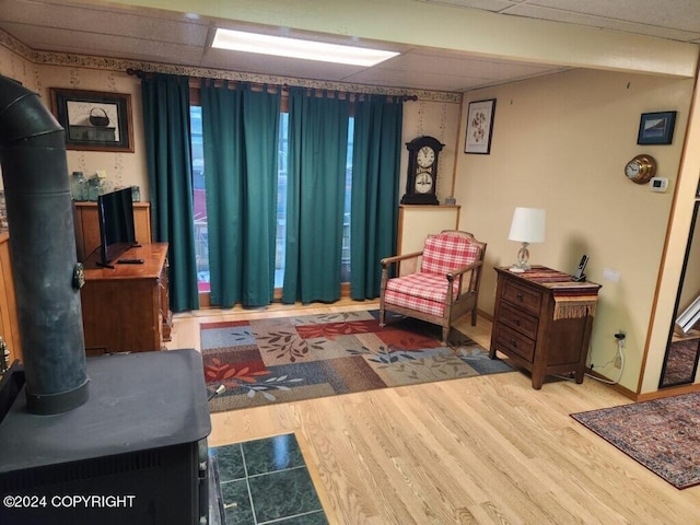 sitting room featuring a drop ceiling and hardwood / wood-style flooring