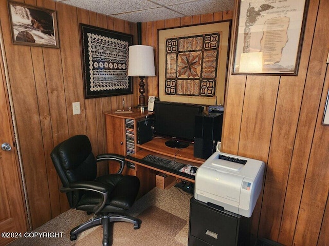 home office featuring carpet floors and wooden walls