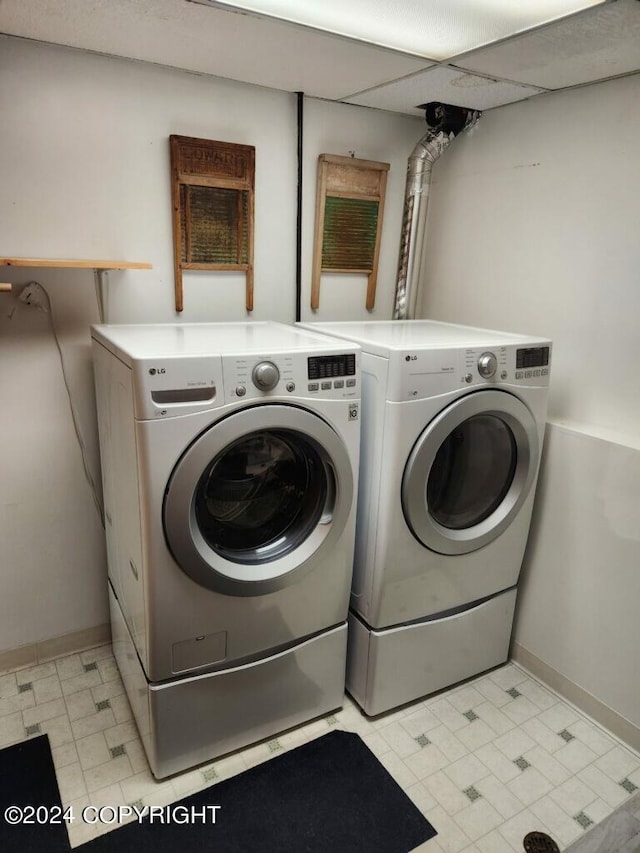 clothes washing area with washing machine and clothes dryer