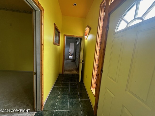 hallway featuring dark tile patterned flooring