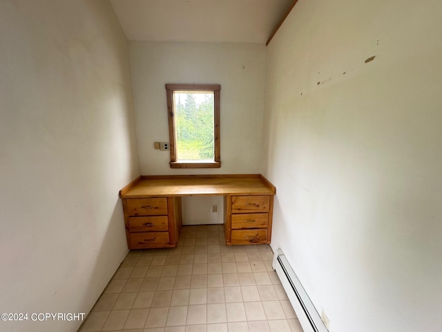 unfurnished office featuring built in desk and a baseboard radiator