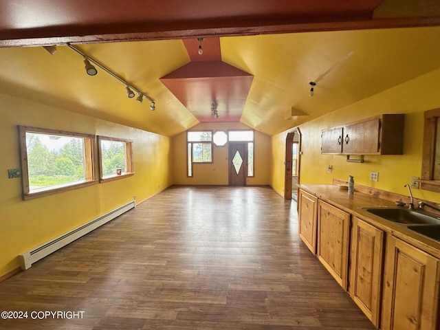 additional living space featuring sink, dark hardwood / wood-style flooring, vaulted ceiling, and a baseboard heating unit