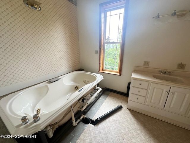 bathroom featuring vanity and a tub