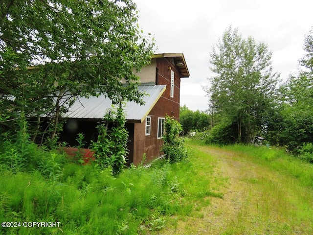 view of property exterior with an outbuilding