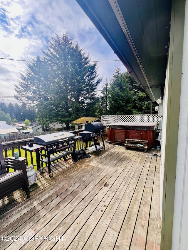 deck featuring grilling area and a hot tub