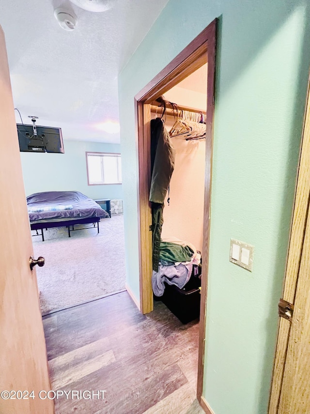 hallway with hardwood / wood-style floors