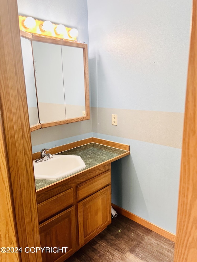 bathroom with vanity and hardwood / wood-style flooring