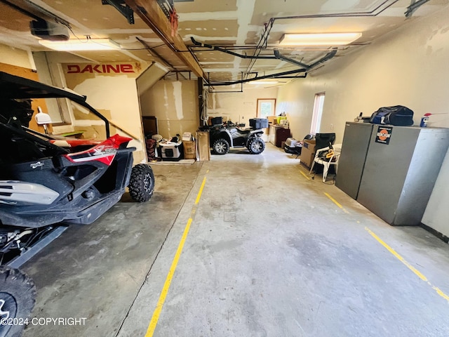 garage with stainless steel fridge