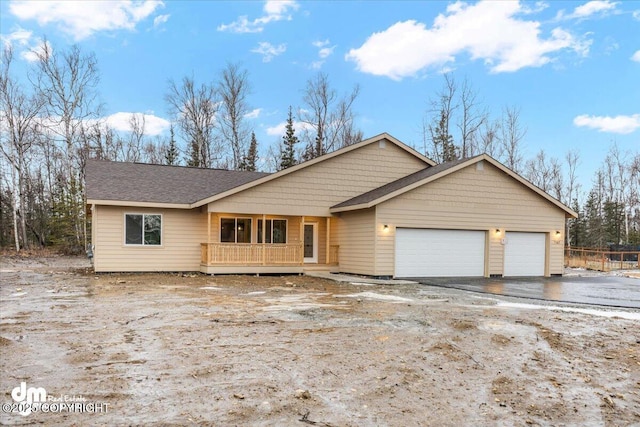 view of front of house with a porch and a garage