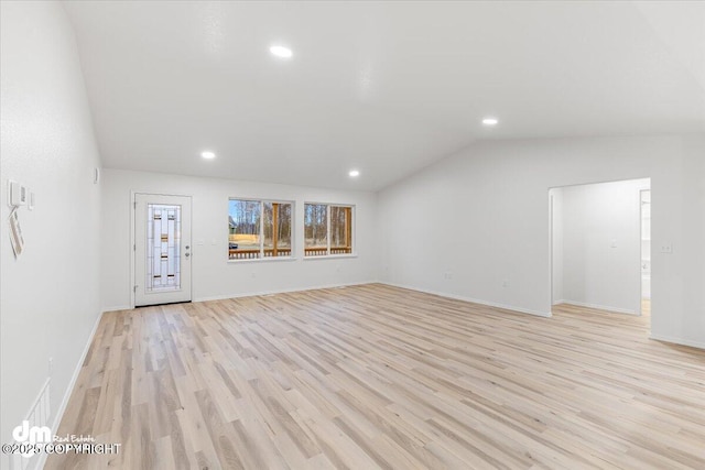 unfurnished living room featuring lofted ceiling and light hardwood / wood-style floors