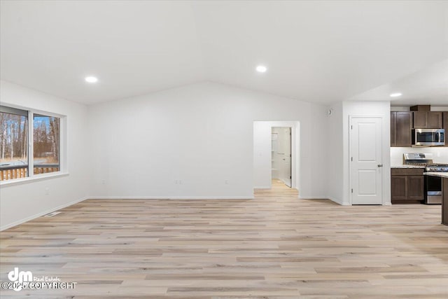 unfurnished living room featuring lofted ceiling and light hardwood / wood-style floors