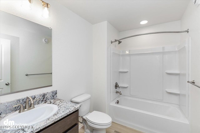 full bathroom with hardwood / wood-style flooring, shower / bathtub combination, vanity, and toilet