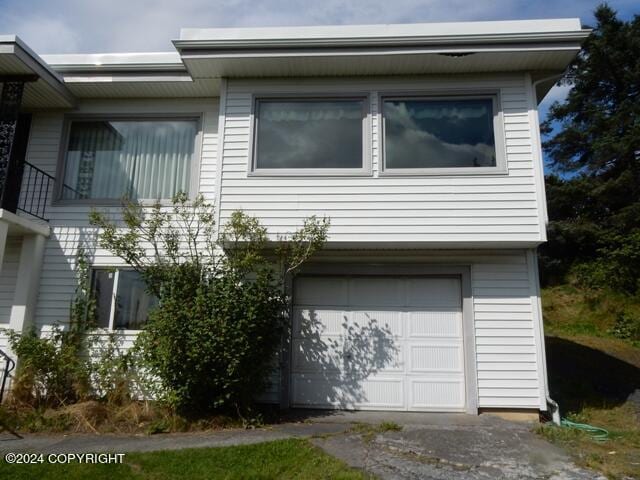 view of side of home featuring a garage