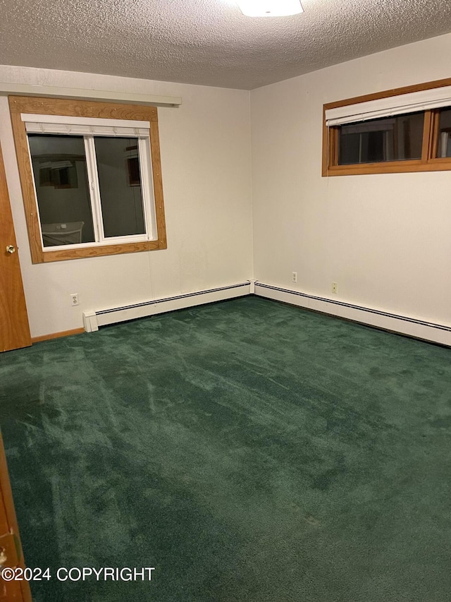 carpeted spare room with a textured ceiling