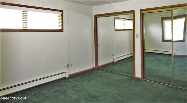 unfurnished bedroom with baseboard heating, dark carpet, and multiple windows