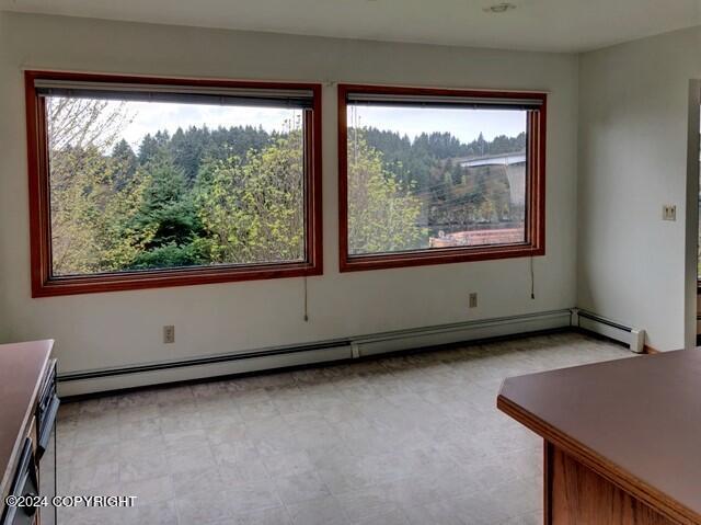 unfurnished room with a baseboard radiator